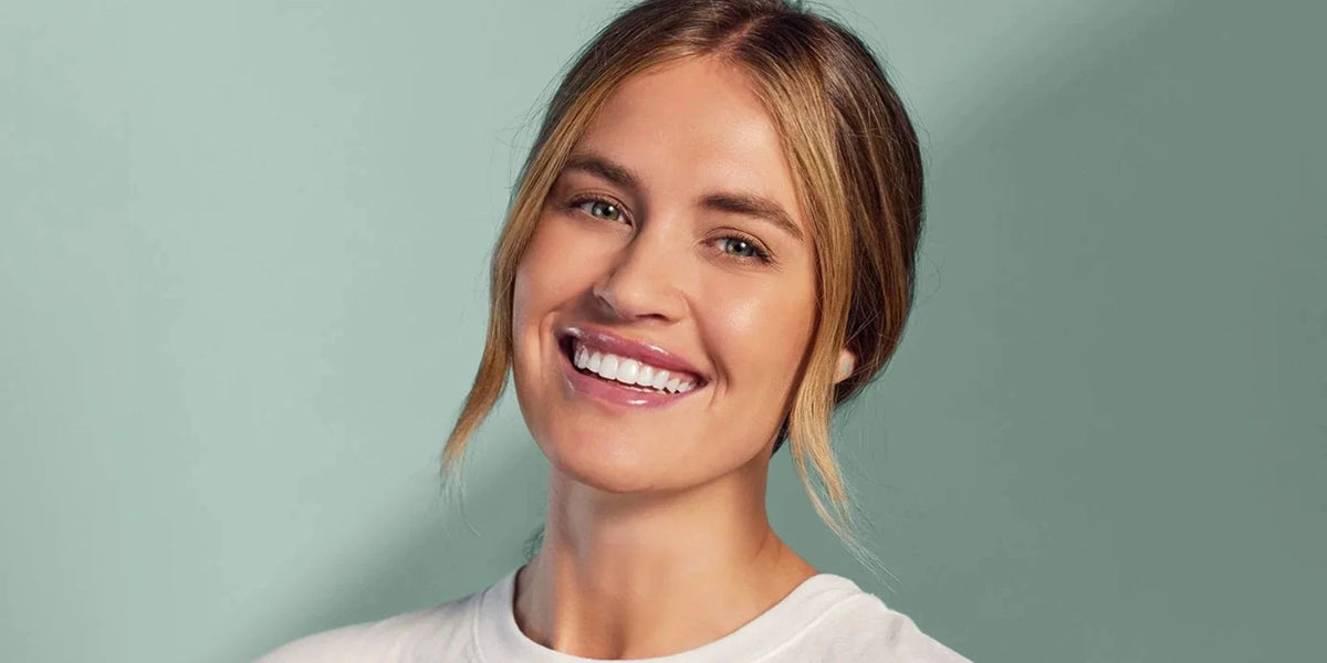 Smiling woman representing simple holiday routines for oral care and travel