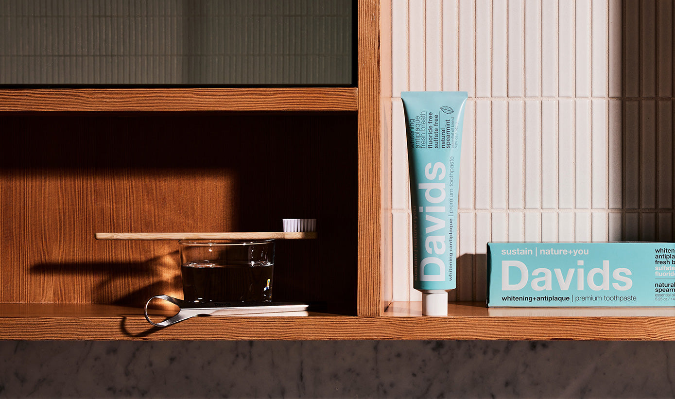 Shelf with Davids Spearmint toothpaste, toothbrush, and tongue scraper with a clean modern design