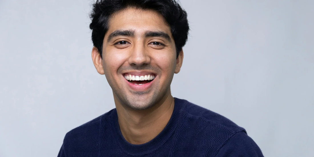 Young man with a big smile wearing a crew neck shirt