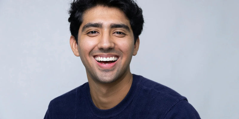 Young man with a big smile wearing a crew neck shirt